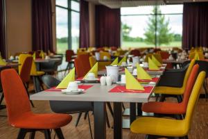 a dining room with tables and chairs at BEST WESTERN Hotel The K Unterföhring in Munich