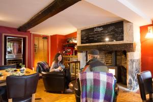 a man and a woman sitting at a table in a restaurant at St.Michaels Bistro in Painswick