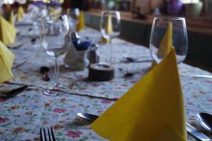 a table with wine glasses and silverware on it at Panoramapension Platzer in Kolbnitz