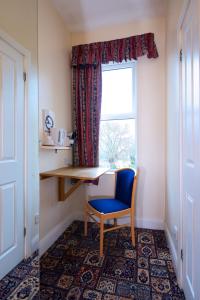 a room with a desk and a chair and a window at The Bournemouth Maemar Hotel in Bournemouth +20 photos
