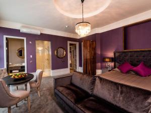 a living room with a couch and a table at Midlands Park Hotel in Portlaoise