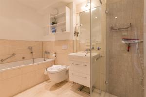 a bathroom with a toilet and a shower and a sink at Villa Allegra in Binz