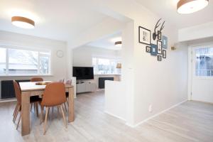 a dining room and living room with a table and chairs at Nordurey Apartments in Reykjavík