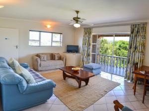 a living room with a blue couch and a table at Sundune Guest House in Colchester