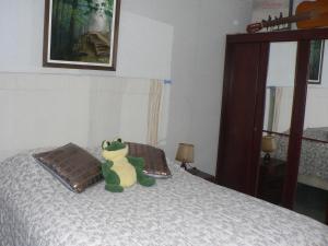 a stuffed animal sitting on top of a bed at Clo Hujobe in Parthenay