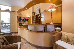 a lobby with a bar with a lamp and chairs at Hotel zur Mühle in Paderborn