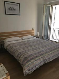 a bedroom with a bed with a blanket on it at La Casetta Due in Teramo