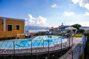 a swimming pool on the side of a house at Hotel Arcangelo - Salina in Santa Marina Salina
