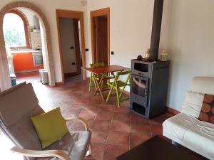 a living room with a stove and a table at Villa l'orto Portixeddu Sardegna in Fluminimaggiore