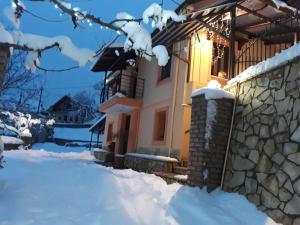 a house in the snow with a stone wall at Patriko in Áyios Nikólaos