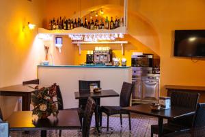 a restaurant with tables and chairs and a kitchen at Hotel Arcangelo - Salina in Santa Marina Salina