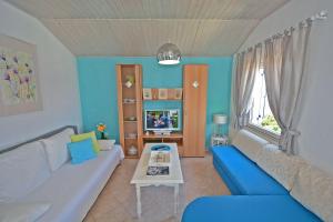 a living room with a couch and a tv at Apartments Residence Sunce Supetar - cozy base to stay and explore Dalmatian archipelago in Supetar