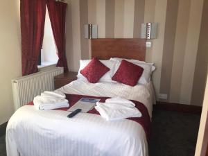 a hotel room with a bed with towels on it at The Globe Inn in Gosforth