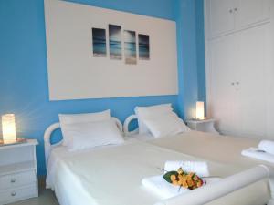 a bedroom with two beds with blue walls at Sirios Apartments in Apraos