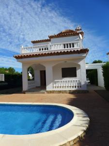 a house with a swimming pool in front of it at Rentalmar Villa California in Miami Platja