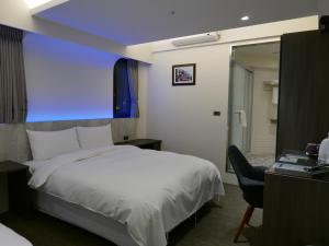 Postel nebo postele na pokoji v ubytování 泊居旅店二館 Oursinn Hotel 2