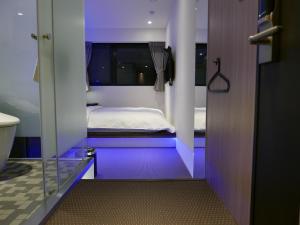 Postel nebo postele na pokoji v ubytování 泊居旅店二館 Oursinn Hotel 2