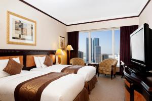 Postel nebo postele na pokoji v ubytování Corniche Hotel Sharjah