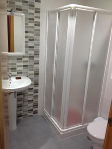 a bathroom with a shower and a sink and a toilet at Pension La Puntica in Lo Pagán