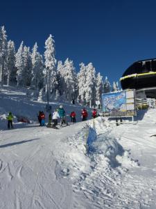 a group of people on a snow covered ski slope at Trzy Strumyki in Kąty Bystrzyckie