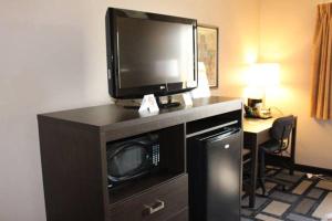 a room with a tv on top of a microwave at Days Inn by Wyndham Watertown in Watertown