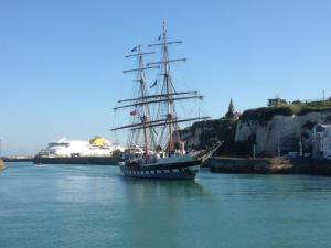 a boat in the water with a cruise ship in the background at 36 Pollet in Dieppe