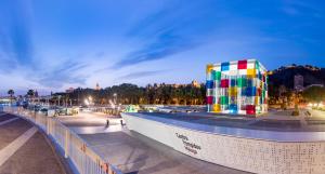 un edificio colorido al lado de un puente en Amazing Apartments Malaga Center, en Málaga