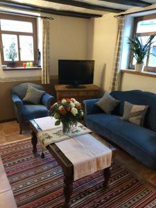 Sala de estar con sofás azules y mesa de centro en Hommes Haus, en Herschbroich