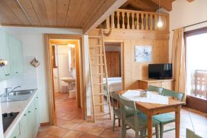 una cucina e sala da pranzo con una casetta di Residence Bait da Mott a Livigno