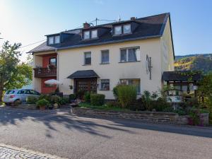 a house with a car parked in front of it at Bed & Breakfast Sandra Müller in Burg an der Mosel