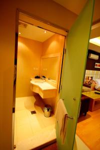 a bathroom with a sink and a mirror at Meera Suites in Riyadh