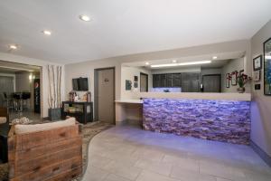 a living room with a blue stone wall at Super 8 by Wyndham Spirit Lake/Okoboji in Spirit Lake