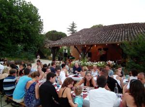 a group of people sitting at tables in a garden at Domaine de Gavaudun in Gavaudun