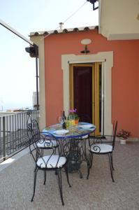 a patio table and chairs on a balcony at La Casarella Apartment Positano in Positano