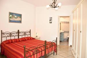a bedroom with a bed with a red blanket at La Casarella Apartment Positano - Stunning View in Positano