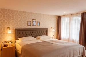 Postel nebo postele na pokoji v ubytování Hotel Walliserhof Zermatt
