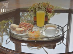 a tray of donuts and a cup of coffee and juice at Hotel Tierra Del Fuego in Punta Arenas