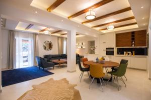 a living room and dining room with a table and chairs at Villa Blue Diamond in Mlini