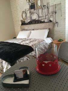 1 dormitorio con 1 cama y 1 mesa con reloj en Suite Romantica Fuga, en Roncone