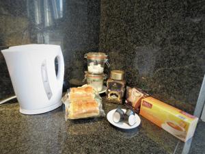 un mostrador con taza de café y comida y una taza en Villa Einstein Apartments, en Amberes