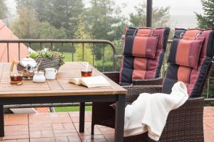 an outdoor table and chairs with a book on a patio at Ferienwohnung "schöner Wohnen" in Westerstede