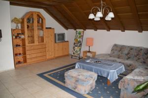 a living room with a couch and a table at Ferienwohnung Margit in Deiningen