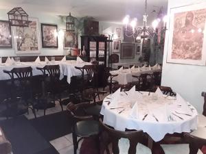 a dining room with white tables and chairs at Gästezimmer in Lindenau in Leipzig