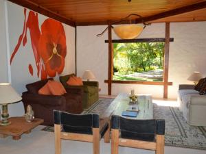 a living room with a couch and a table and chairs at Camauí Hotel in Barra Grande