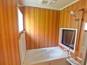 a bathroom with a bath tub and a tv at Shounsai in Kyoto