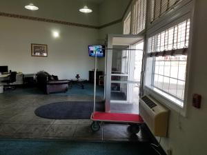 a room with a living room with a room with a glass door at Simple Rewards Inn in Guymon