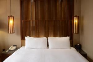 Voodi või voodid majutusasutuse Guide Hotel Taipei Bade toas