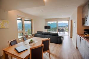 a kitchen and living room with a table and a couch at Residence Prunarhof in Caldaro