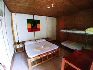 A bed or beds in a room at Reggae Guesthouse