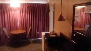 a room with two tables and a red curtain at Cedar Inn in McCook
